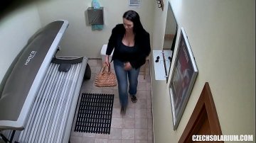 young woman secretly filmed tanning solarium.
